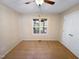 Cozy bedroom with a ceiling fan, double closet, and large window providing natural light and views at 110 Chickasaw Cir, Clayton, NC 27527