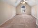 This bedroom shows a vaulted ceiling, neutral carpet and a large window at 110 Chickasaw Cir, Clayton, NC 27527