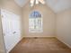 Bedroom featuring a vaulted ceiling, carpet, closet, and large window with natural light at 110 Chickasaw Cir, Clayton, NC 27527