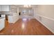 Open-concept dining area features wood floors, a view of the living room, and access to the kitchen at 110 Chickasaw Cir, Clayton, NC 27527