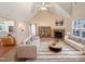 Bright, virtually staged living room with vaulted ceilings, fireplace and neutral decor at 110 Chickasaw Cir, Clayton, NC 27527