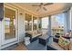 Cozy back porch area with modern outdoor furniture and a ceiling fan for comfortable outdoor living at 112 Ava Ct, Holly Springs, NC 27540