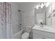Clean bathroom with a shower/tub, toilet, sink with large mirror and vanity at 112 Ava Ct, Holly Springs, NC 27540