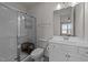 Modern bathroom with a glass-enclosed shower, white vanity, and neutral color palette at 112 Ava Ct, Holly Springs, NC 27540