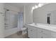 Bright bathroom with a shower-tub combo, a sink, and a large mirror for good lighting at 112 Ava Ct, Holly Springs, NC 27540