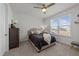 Cozy bedroom featuring a comfortable bed, ceiling fan, and a large window with natural light at 112 Ava Ct, Holly Springs, NC 27540