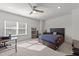 Comfortable bedroom with a ceiling fan, a view of outside, and a modern wooden bedframe at 112 Ava Ct, Holly Springs, NC 27540