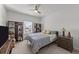 Traditional bedroom with a ceiling fan, a window, and bookshelves with organized storage at 112 Ava Ct, Holly Springs, NC 27540