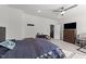 Spacious bedroom with a ceiling fan, a large TV set, and comfortable wooden bedframe at 112 Ava Ct, Holly Springs, NC 27540