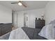 A comfortable bedroom space with ceiling fan, dresser and view into the ensuite bathroom at 112 Ava Ct, Holly Springs, NC 27540