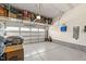 Spacious garage with an epoxy floor, overhead storage racks, and a clean, organized layout at 112 Ava Ct, Holly Springs, NC 27540