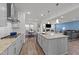 Spacious kitchen featuring stainless appliances, granite counters, and seamless flow to living area at 112 Ava Ct, Holly Springs, NC 27540