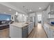 Open concept kitchen with a large island, stainless steel appliances and hardwood flooring at 112 Ava Ct, Holly Springs, NC 27540