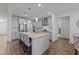 Modern kitchen boasts gray cabinets, a granite island with seating, and stainless steel appliances at 112 Ava Ct, Holly Springs, NC 27540