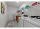 Functional laundry room equipped with modern appliances and ample storage space on shelving at 112 Ava Ct, Holly Springs, NC 27540