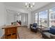 Bright and airy living room featuring neutral paint, natural light and access to office and front door at 112 Ava Ct, Holly Springs, NC 27540
