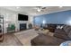 Comfortable living room featuring a fireplace, a large TV, and a comfortable sectional sofa at 112 Ava Ct, Holly Springs, NC 27540