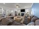 Open-concept living room with a fireplace, built-in shelving, and seamless flow to the dining area at 112 Ava Ct, Holly Springs, NC 27540