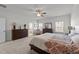 Spacious main bedroom with neutral color palette, plush carpet and luxurious ensuite bathroom at 112 Ava Ct, Holly Springs, NC 27540