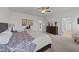 Comfortable main bedroom with neutral decor, carpet flooring and view into large ensuite bath at 112 Ava Ct, Holly Springs, NC 27540