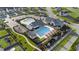 Aerial view of a community pool, playground, and clubhouse with manicured landscaping at 112 Ava Ct, Holly Springs, NC 27540