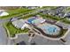 Aerial view of a community pool and clubhouse with ample parking at 112 Ava Ct, Holly Springs, NC 27540