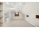 Large attic with skylight, built-in shelves and a ceiling fan at 113 Preston Pines Dr, Cary, NC 27513