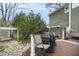 Outdoor back deck features a grill, patio seating, and a serene view of the backyard garden at 113 Preston Pines Dr, Cary, NC 27513