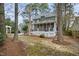 Expansive backyard boasts a screened porch, stairs, mature trees, and lush greenery, creating a private retreat at 113 Preston Pines Dr, Cary, NC 27513
