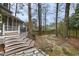 Multi-tiered backyard with stone patio, stairs, and lush greenery offers a private outdoor retreat at 113 Preston Pines Dr, Cary, NC 27513