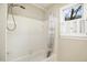 Bright bathroom featuring a window with plantation shutters and a white shower at 113 Preston Pines Dr, Cary, NC 27513