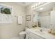 Bright bathroom featuring a window with plantation shutters and a large mirror at 113 Preston Pines Dr, Cary, NC 27513