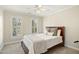 Comfortable bedroom with neutral tones, shutters and a ceiling fan at 113 Preston Pines Dr, Cary, NC 27513