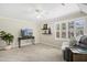 Carpeted bonus room featuring a ceiling fan, media console, seating and plantation shutters at 113 Preston Pines Dr, Cary, NC 27513