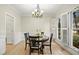 Bright dining room featuring hardwood floors, elegant lighting, and large windows at 113 Preston Pines Dr, Cary, NC 27513