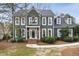 Charming two-story home with detailed trim, mature landscaping, and inviting front porch at 113 Preston Pines Dr, Cary, NC 27513