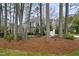 Lovely view of the home situated amongst mature trees and lush landscaping at 113 Preston Pines Dr, Cary, NC 27513