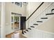 Elegant foyer with hardwood floors, decorative trim, and staircase at 113 Preston Pines Dr, Cary, NC 27513