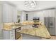 Elegant kitchen with stainless steel appliances, granite countertops, and custom cabinets at 113 Preston Pines Dr, Cary, NC 27513