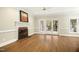 Bright living room featuring a fireplace, hardwood floors, and French doors to the outdoor space at 113 Preston Pines Dr, Cary, NC 27513