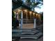 Exterior view of the screened porch with lights and wooden steps, an ideal space for outdoor enjoyment at 113 Preston Pines Dr, Cary, NC 27513