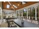 Spacious screened porch with skylights, ceiling fans, dining and living areas, blending indoor-outdoor living at 113 Preston Pines Dr, Cary, NC 27513