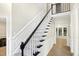 Classic staircase with dark wood railing and white posts, creating a timeless aesthetic at 113 Preston Pines Dr, Cary, NC 27513