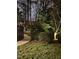 Charming walkway leading to the home, surrounded by mature trees and beautiful landscaping and lovely garden lights at 113 Preston Pines Dr, Cary, NC 27513