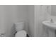 Powder room featuring a pedestal sink and toilet with modern fixtures and ample space at 117 Pisgah St, Sanford, NC 27330