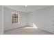 Cozy bedroom with a large window, fresh paint and carpet flooring, creating a serene and comfortable space at 117 Pisgah St, Sanford, NC 27330