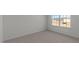 Cozy bedroom with natural light streaming through a window, enhanced by plush carpeting at 117 Pisgah St, Sanford, NC 27330