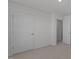 Bedroom with neutral carpet and an interior door plus a closet, providing comfort and functionality at 117 Pisgah St, Sanford, NC 27330