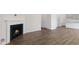 Open-concept living room with a modern fireplace and stylish wood flooring, offering a welcoming space at 117 Pisgah St, Sanford, NC 27330