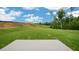 Expansive backyard featuring a concrete patio, lush green lawn, and ample space for outdoor activities at 120 Pisgah St, Sanford, NC 27330